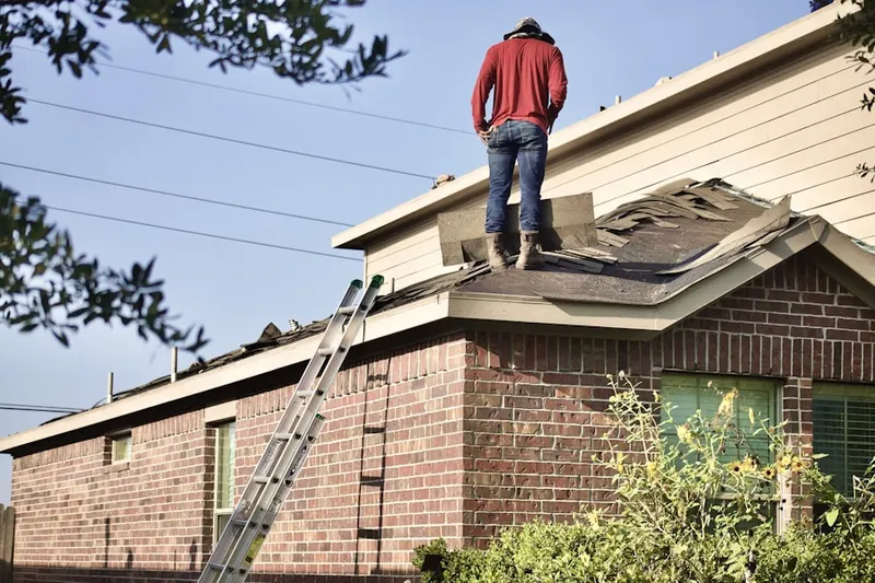 Professional roofer working on a residential roof in Columbia Point